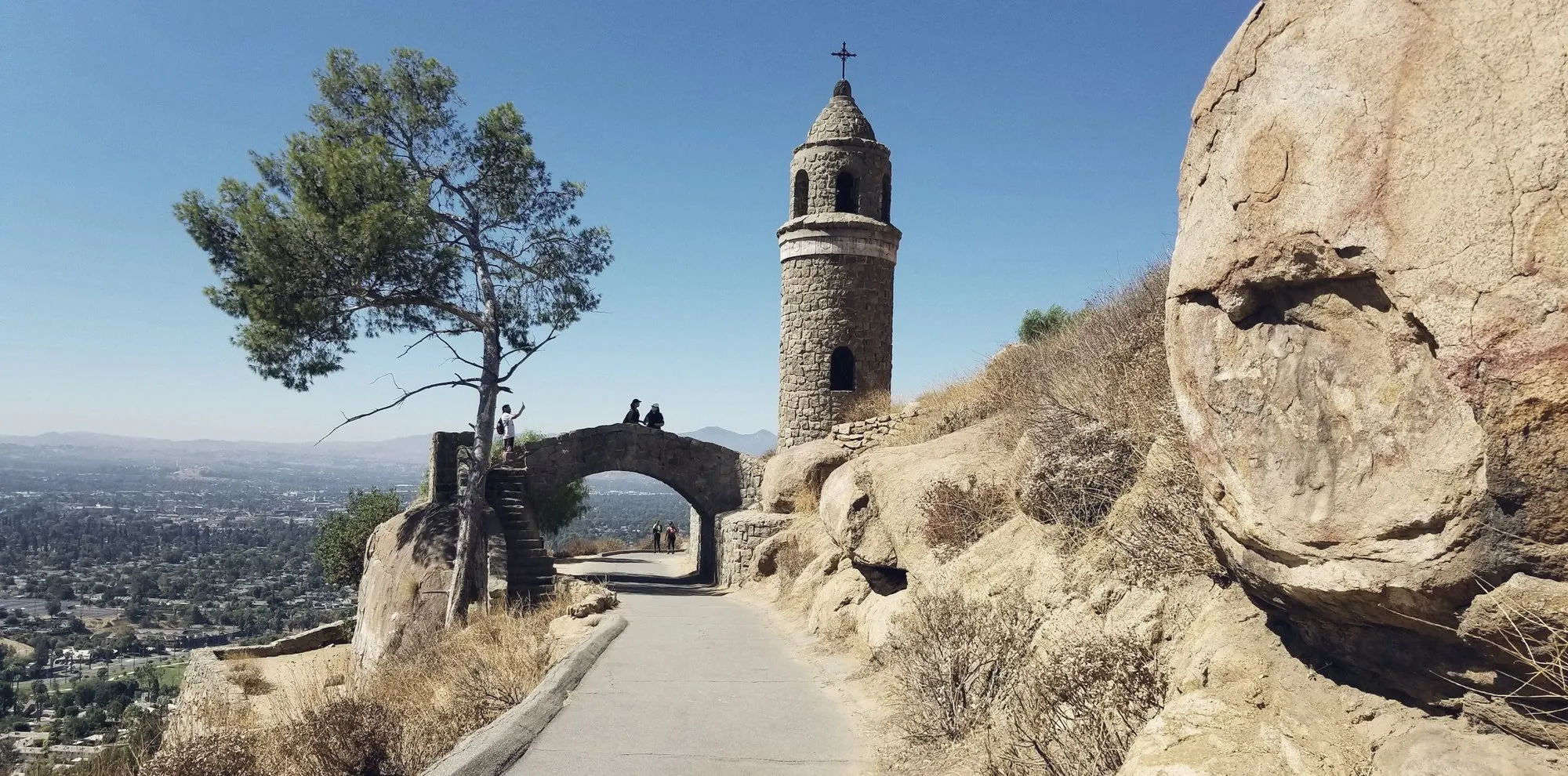 A stone bell tower and arched bridge atop Mount Rubidoux overlooking Riverside.
