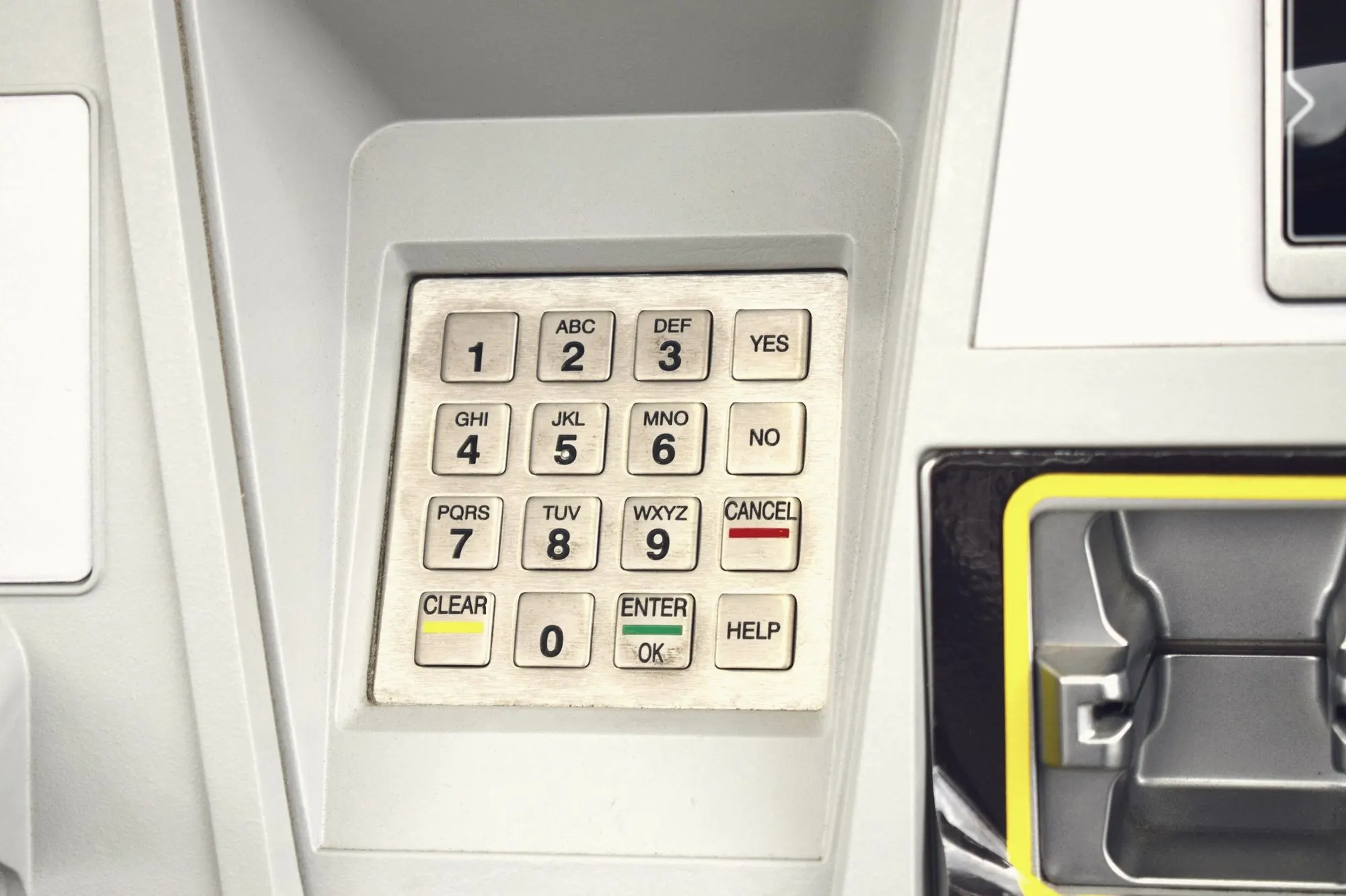A clean retail ATM keypad beside a card slot.